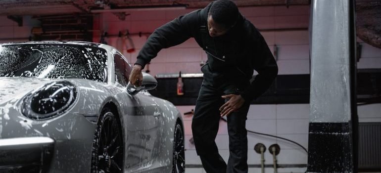 A man cleaning his car before putting it in vehicle storage
