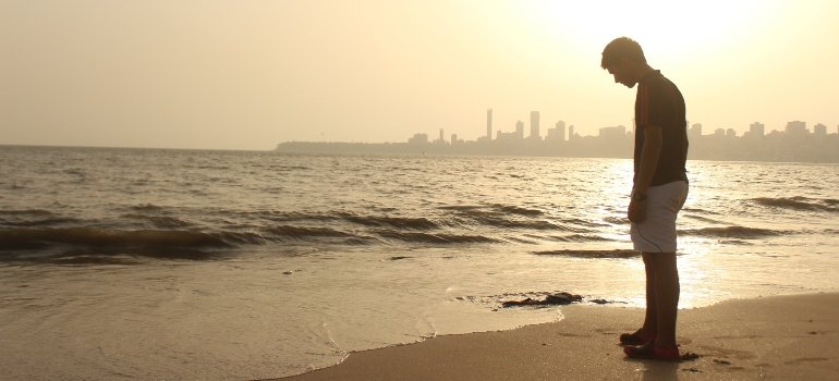 a sad person on a beach