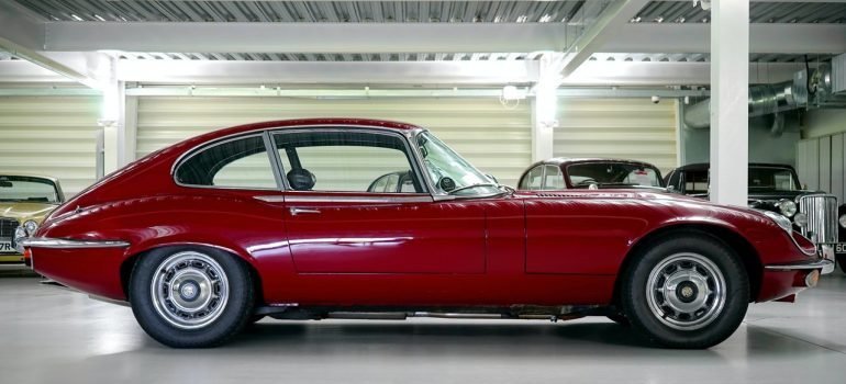 A red classic car inside the car storage NYC residents recommend