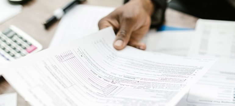 two people signing documents