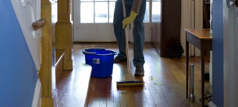 a man mopping the floors