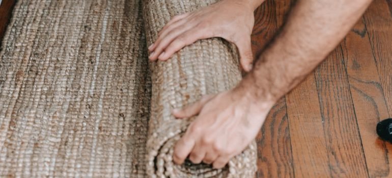 Unrolling a rug.