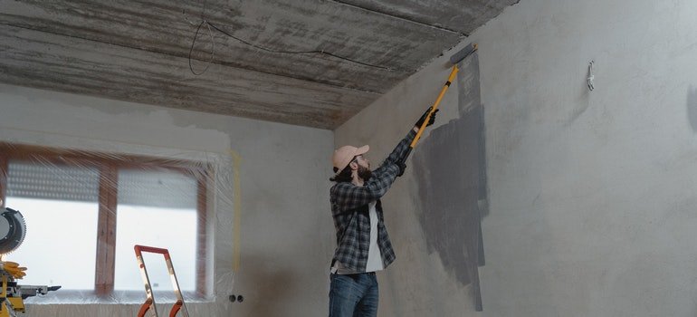 person painting a wall