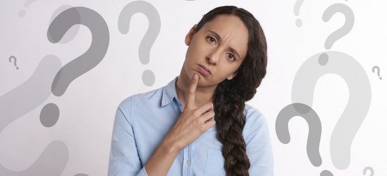 A woman surrounded by question marks.