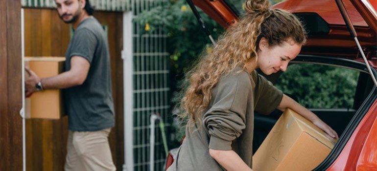 a couple loading a car with boxes as one of the storage mistakes to avoid