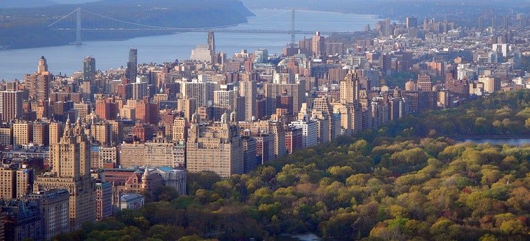 a view of Central Park, the river and nearby buildings in New York