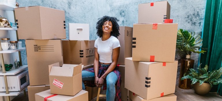 a girl sitting between boxes