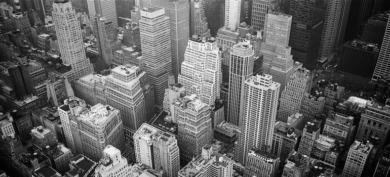 a view of tall buildings from above in black and white