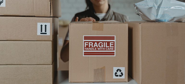a woman placing boxes on shelves