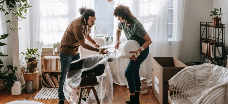 A couple packing furniture