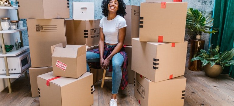 A woman ready to pack and organize a storage unit.