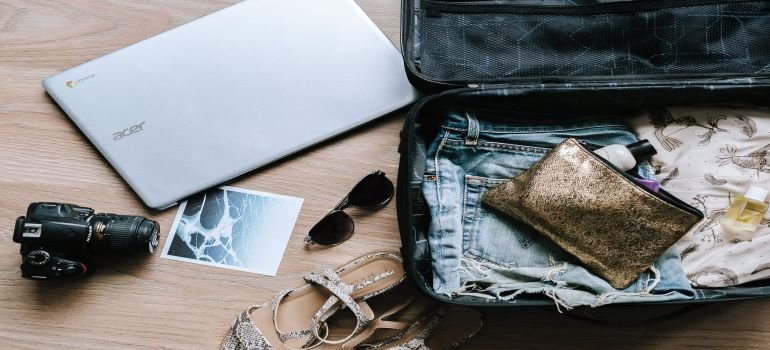 An essentials bag filles with clothes and electronics