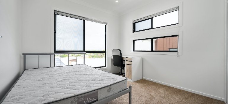 A bed without bed covers in almost empty is the first step to dismantle a king-sized bed.