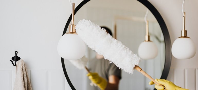 woman cleaning before stage your Manhattan apartment for sale