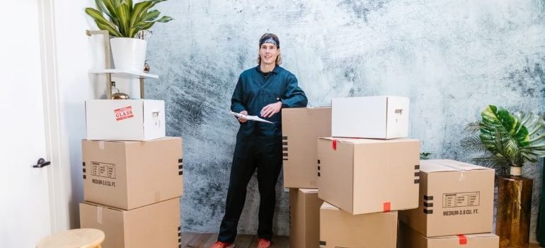mover leaning on the cardboard boxes