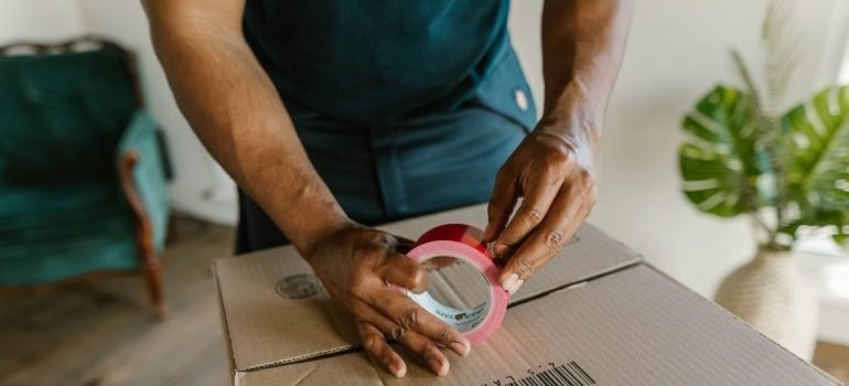 A man securing a box