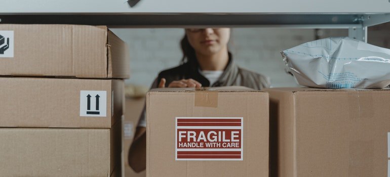 person packing items into storage