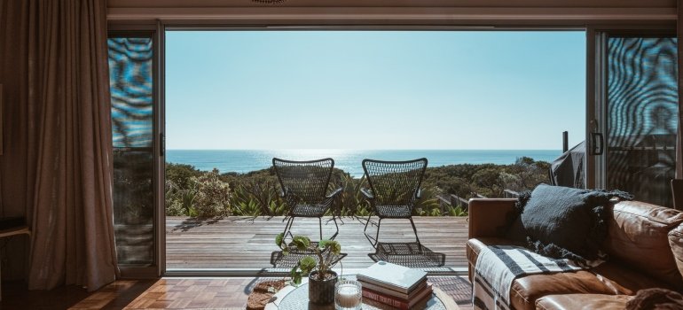 An apartment with a balcony looking over the sea