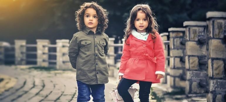 two kids standing on a bridge