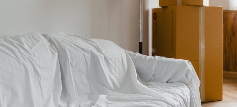 A couch covered with a sheet