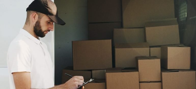 A man calculating what can he fit in different storage sizes