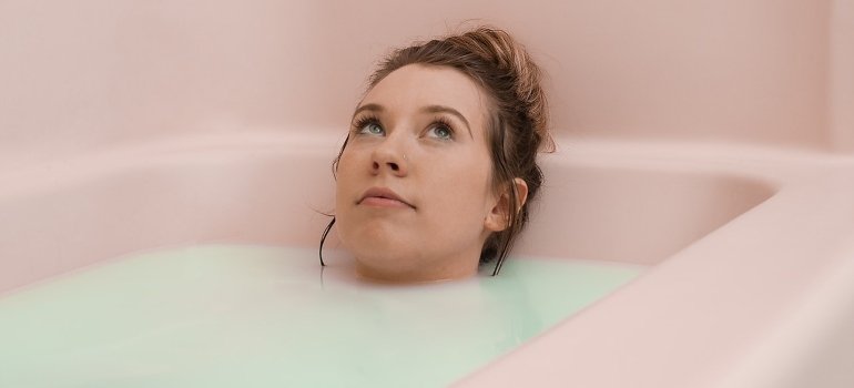 A woman thinking in the bathtub