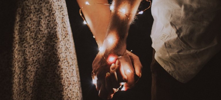 couples moving in together and holding hands