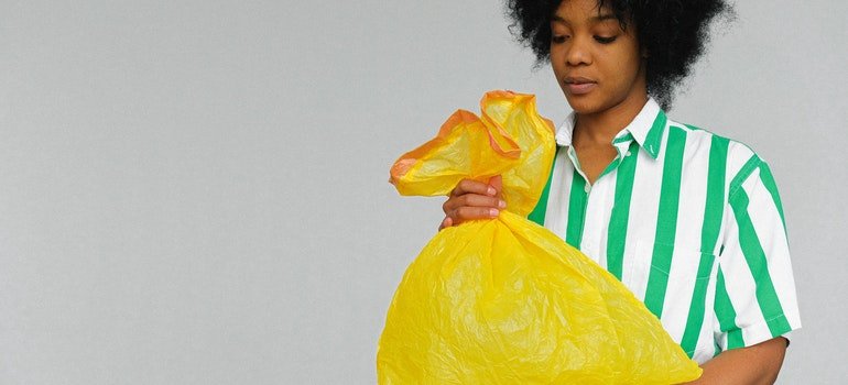 woman holding a trash bag