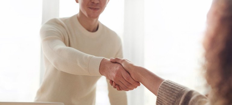 Man shaking hands after following guide to document storage and renting storage from a reputable company