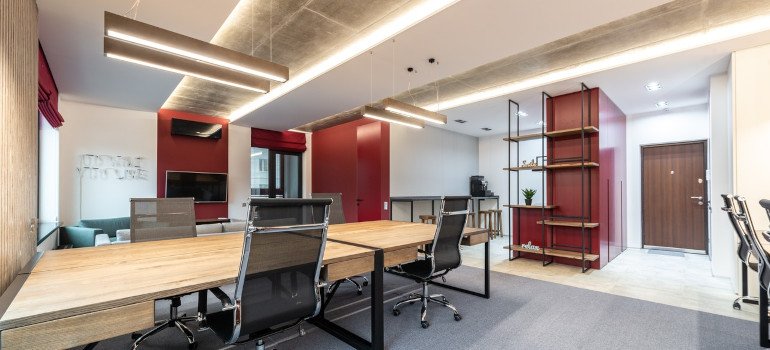 Office interior with table and chairs near shelves
