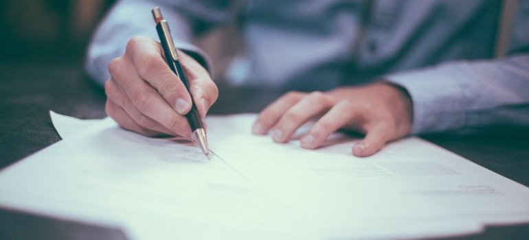 A man signing an insurance document
