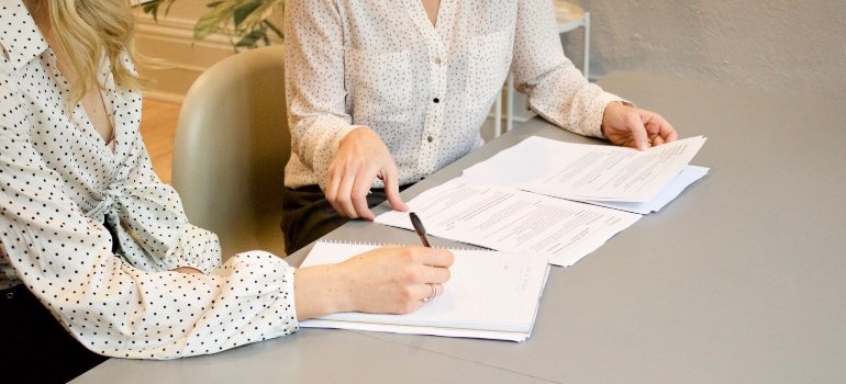 A woman signing a contract