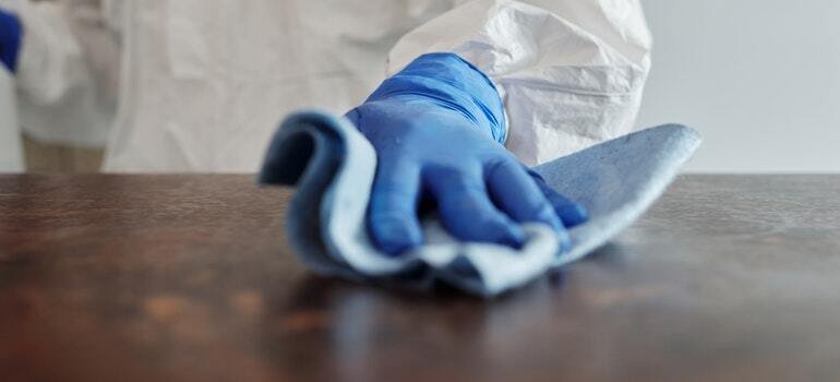 A person cleaning a table