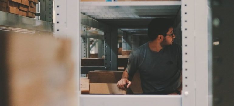 Man placing things in storage