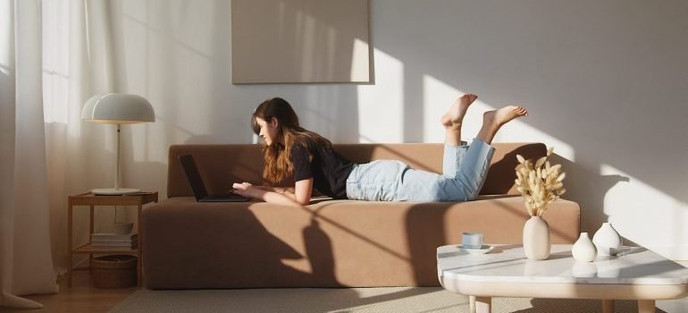 A girl laying down using her laptop.