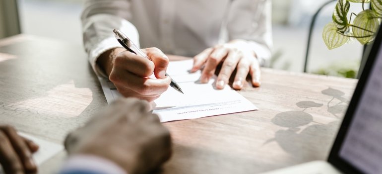 A woman signing her lease for the apartment