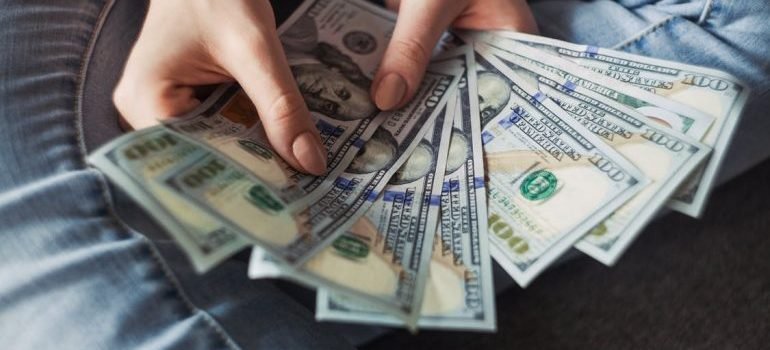 A person holding dollar bills