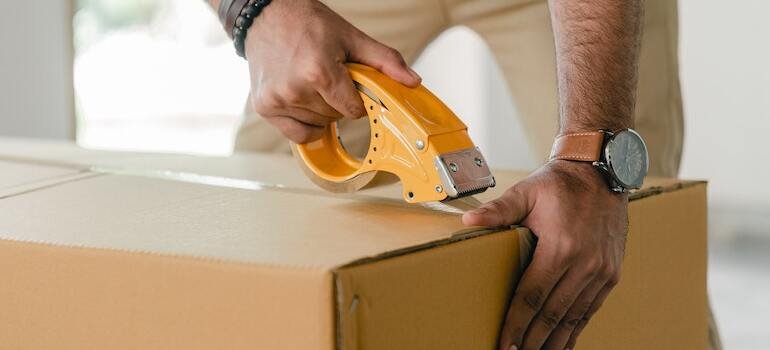 A person packing up a moving box