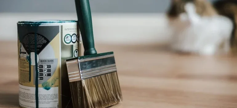 Paint brush with paint on the floor