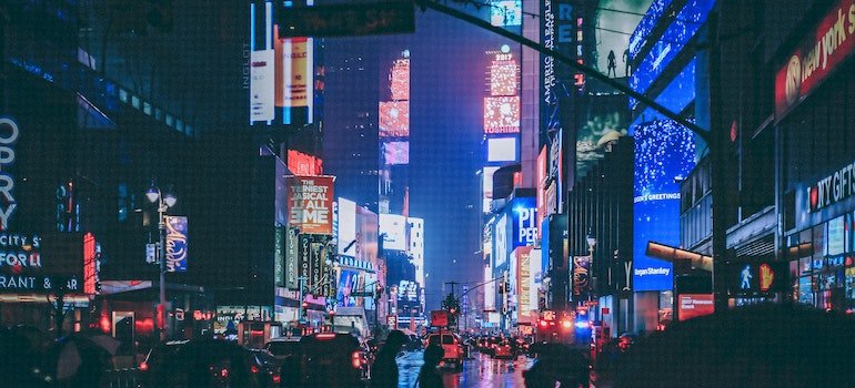 People walking in the night city streets in NY.