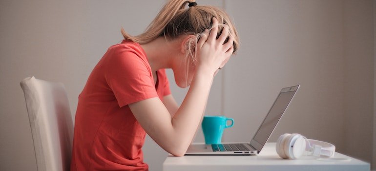 A stressed person looking at laptop