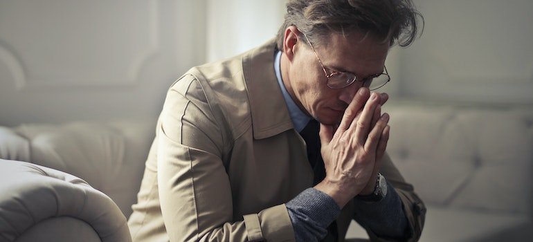 a man thinking about why to store your belongings during economic hardship