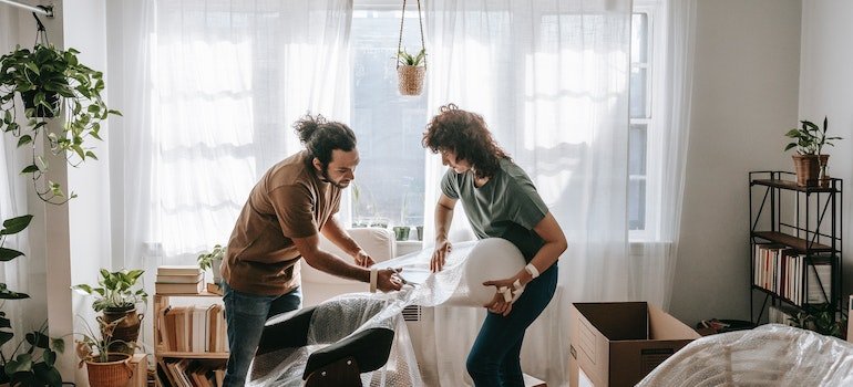 A couple packing furniture