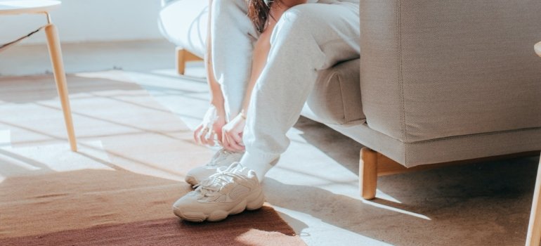 a girl putting her shoes on