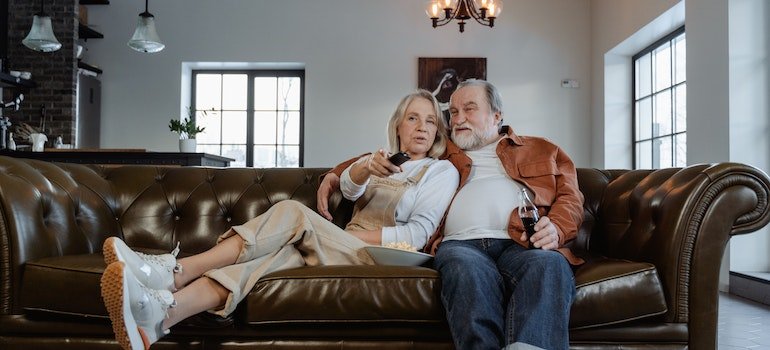 Man and Woman Sitting on Couch after leaving Manhattan to retire.