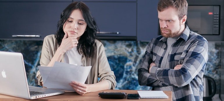 Couple looking at documents on how to sell you NYC home faster by staging it.