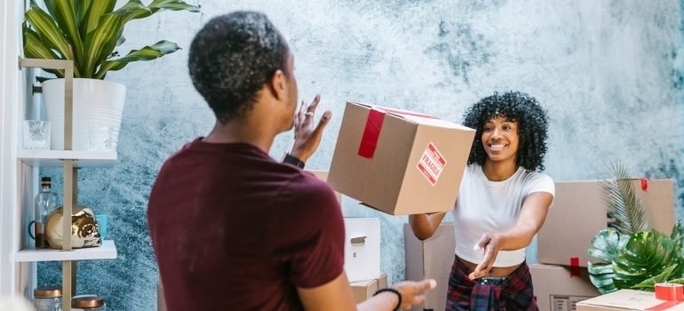 man and woman throwing a box