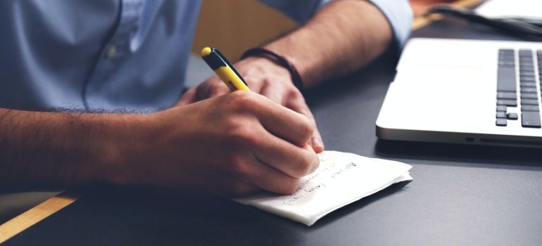 a person writing on a piece of paper