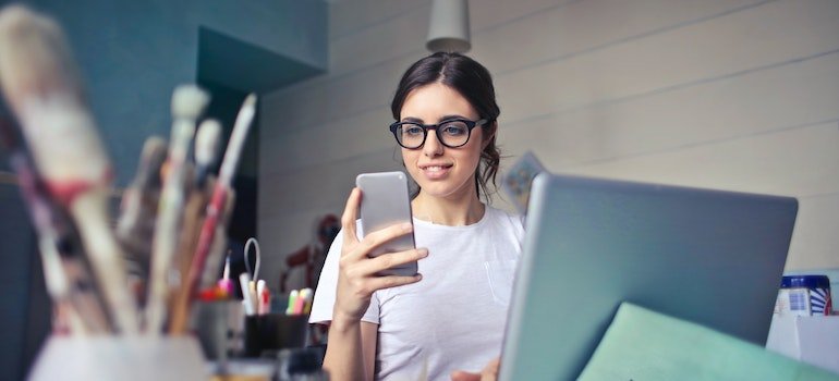 a young woman reading tips to store electronic equipment oh her cell phone