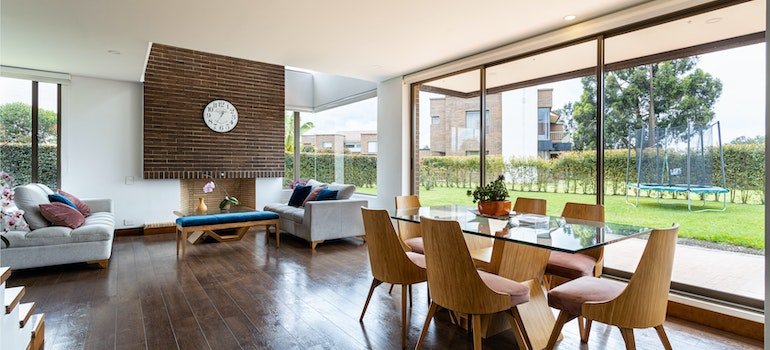a large living room with a couch and dinner table with chairs